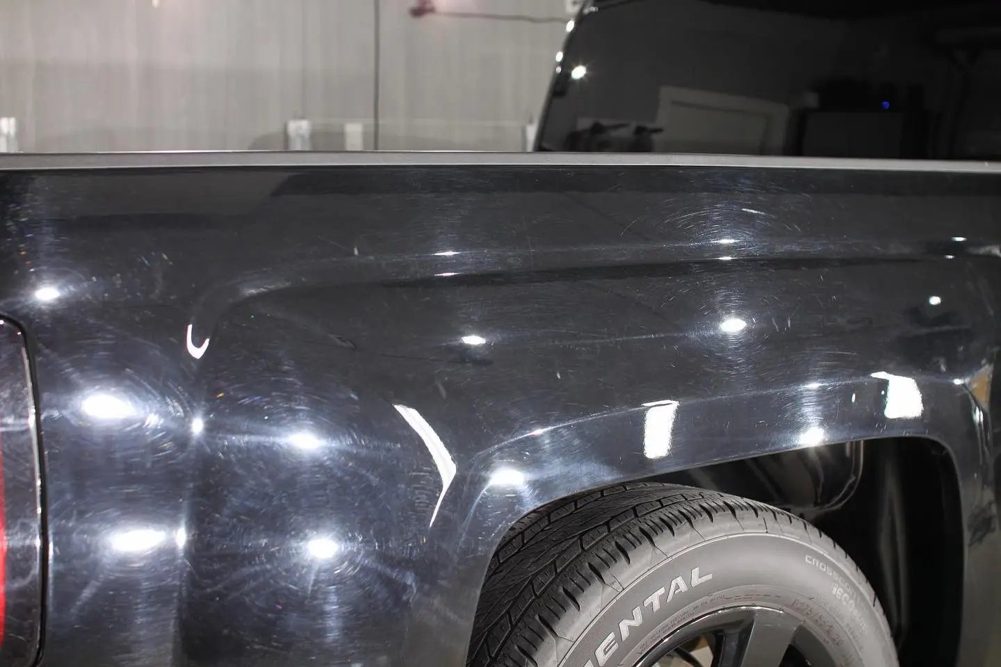 Swirled black paint before correction